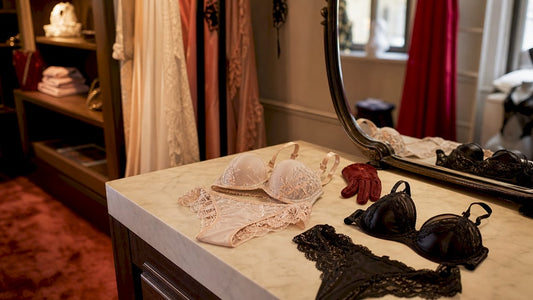 Une table met en avant deux collections de lingerie soigneusement exposées dans la cabine d’essayage de la boutique.