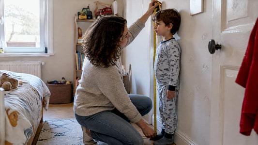 Un parent mesure la taille de son enfant